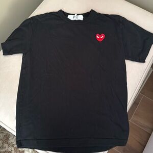 Size medium black comme de garçon tshirt with logo on top corner. Worn twice